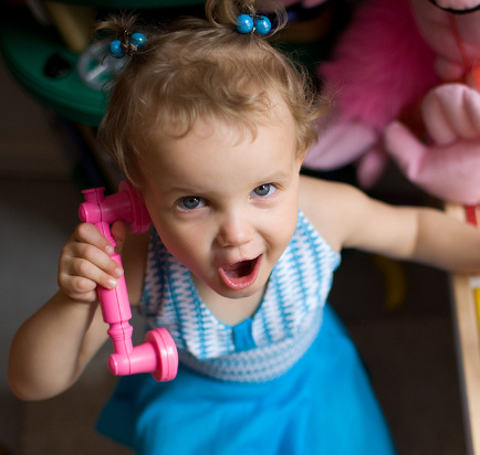 little girl on pink phone