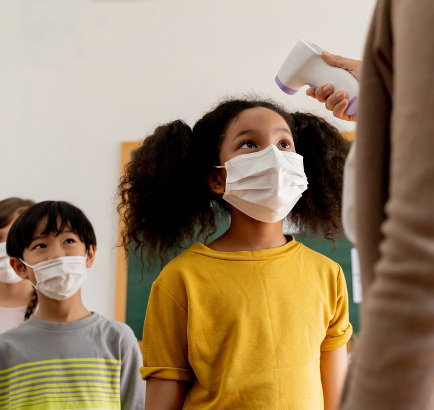 girl getting temperature checked